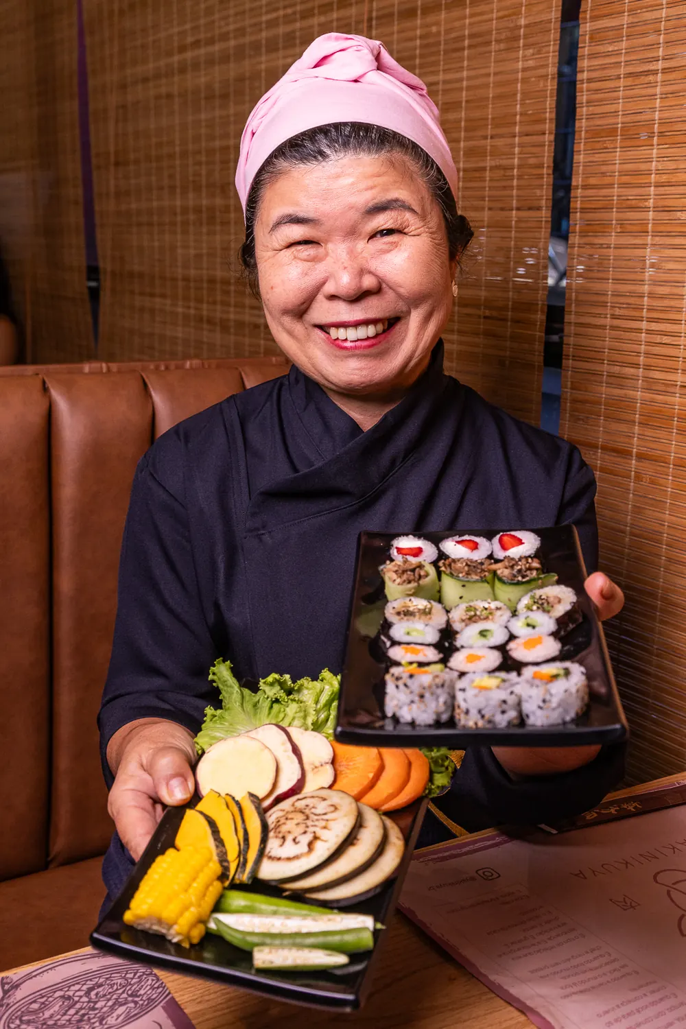 Retrato da Chef Rosa Takematsu com pratos do Yakinikuya
