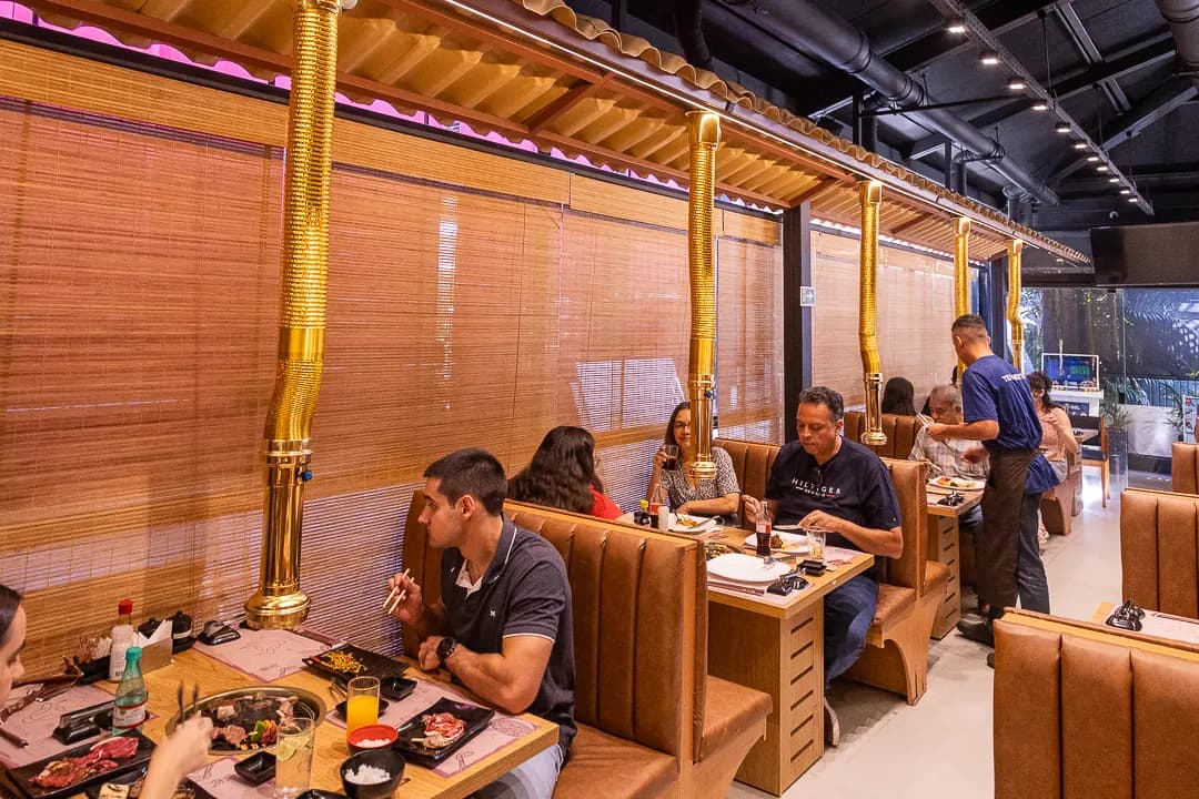 Salão do Yakinikuya com mesas e clientes